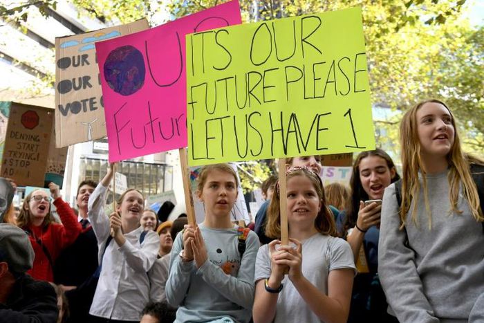 Students hold up placards during an environmental protest in Melbourne on May 3, 2019