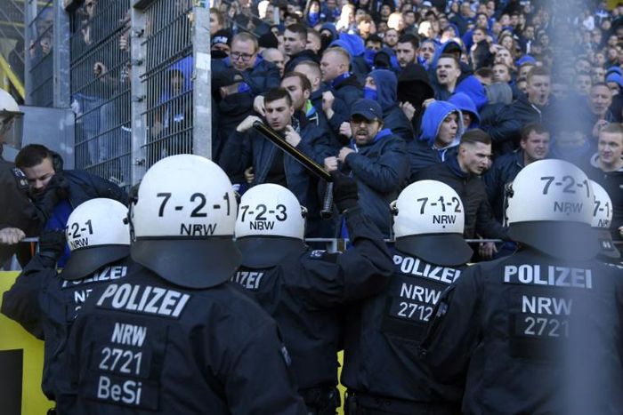 Schalke's supporters face police officers during a heated local derby against Borussia Dortmund on Saturday