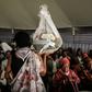 A woman carries flowers to offer before the mass funeral to bury 81 coffins containing newly discoverd remains of 84,437 victims of the 1994 genocide in the mass grave at the Nyanza Genocide Memorial, suburb of the capital Kigali, on May 4, 2019. The r...