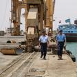 Yemeni coast guards walk at Saleef port in the western Red Sea Hodeida province after their redeployment following the withdrawal of Huthi rebel fighters, on May 13, 2019