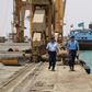 Yemeni coast guards walk at Saleef port in the western Red Sea Hodeida province after their redeployment following the withdrawal of Huthi rebel fighters, on May 13, 2019