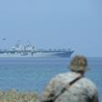 US Marines watch the US navy multipurpose amphibious assault ship 'USS Wasp' with F-35 lightning fighter jets on the deck during the annual joint US-Philippines military exercise on April 11, 2019