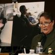 Carla Provost, chief of the US Border Patrol, speaks during a Senate hearing in front of pictures of border patrol agents assisting children