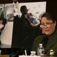 Carla Provost, chief of the US Border Patrol, speaks during a Senate hearing in front of pictures of border patrol agents assisting children