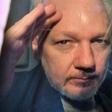 Assange gestured from the window of a prison van as he was driven out of Southwark Crown Court on Wednesday
