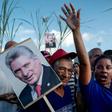 A woman holds a poster of Cuban president Miguel Diaz-Canel during the May Day rally in Havana's Revolution Square on May 1, 2019