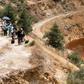 Journalists look on as Cyprus forensic police officers investigating the murder of seven women and girs search a lake outside Mitsero village, southwest of the capital Nicosia on April 30, 2019