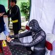 Election officials dressed as cartoon superheroes in Surabaya to encourage voters to come to the polling station
