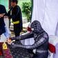 Election officials dressed as cartoon superheroes in Surabaya to encourage voters to come to the polling station