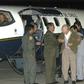 The sect's founder Paul Schaefer (centre), seen in March 2005, is helped aboard a Chilean Air Force Plane in Buenos Aires after being expelled from Argentina to Chile, where he died in jail