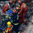 About half of the low-rise building collapsed in Shanghai, crushing construction workers under piles of toppled concrete pillars and shattered wooden beams