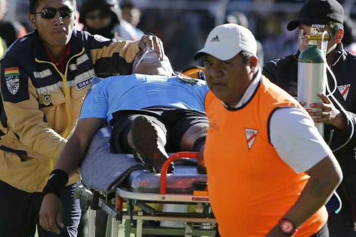Bolivian referee Victor Hugo Hurtado is taken away on a stretcher during Bolivia's first division football match between Always Ready and Oriente Petrolero at the Municipal Stadium in El Alto, Bolivia on May 19, 2019