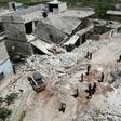 Members of the Syrian Civil Defence (White Helmets) clear rubble to open a road following reported shelling on the village of Ibdita in the Idlib province on May 8, 2019