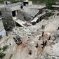 Members of the Syrian Civil Defence (White Helmets) clear rubble to open a road following reported shelling on the village of Ibdita in the Idlib province on May 8, 2019