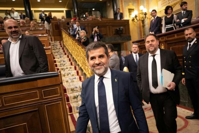 Jailed Catalan elected members of parliament Jordi Sanchez (2L) and Oriol Junqueras (2R) attend the plenary session of the lower house of parliament since last month's general election in Madrid on May 21, 2019
