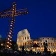 A cross lit with candles in front of the Coliseum in Rome ahead of the Way of the Cross procession