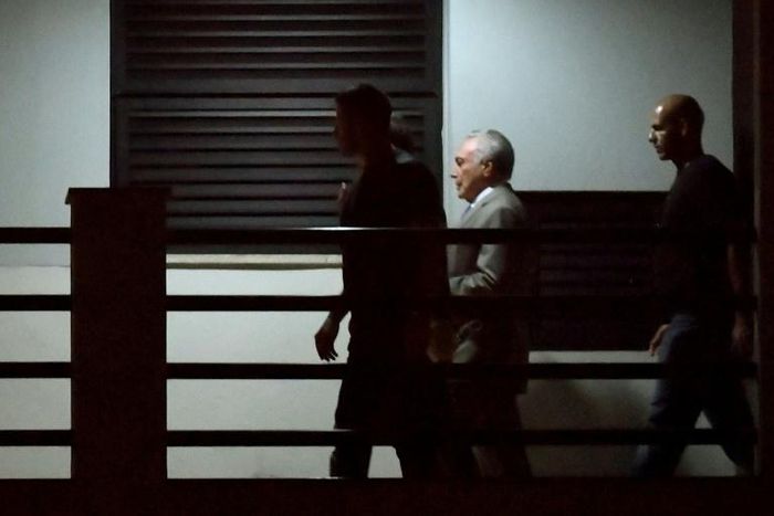 Brazil's former president Michel Temer (C), arrives under police escort at the Federal Police headquarters in Rio de Janeiro, Brazil, on March 21, 2019 after being arrested