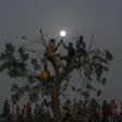 Sudanese protesters keep up a nightime vigil outside the army complex in the capital Khartoum