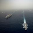 The US aircraft carrier USS Abraham Lincoln, on the left, sails in formation in the Mediterranean alongside British, French, Spanish and other US warships last month in an image released by the US Navy