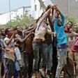 African migrants receive food and water inside a football stadium in the Red Sea port city of Aden in Yemen, on April 23, 2019
