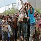 African migrants receive food and water inside a football stadium in the Red Sea port city of Aden in Yemen, on April 23, 2019