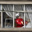 A fire fighter inspects the damage at a factory in Bogota where an explosion killed four people and left 29 injured