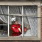 A fire fighter inspects the damage at a factory in Bogota where an explosion killed four people and left 29 injured