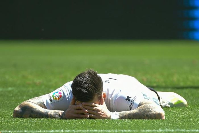 Valencia's Santi Mina lies on the field during their 1-0 defeat to Eibar on Sunday
