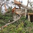 A woman inspects the damage caused by Cyclone Kenneth to her home in Macomia, in the north of Mozambique