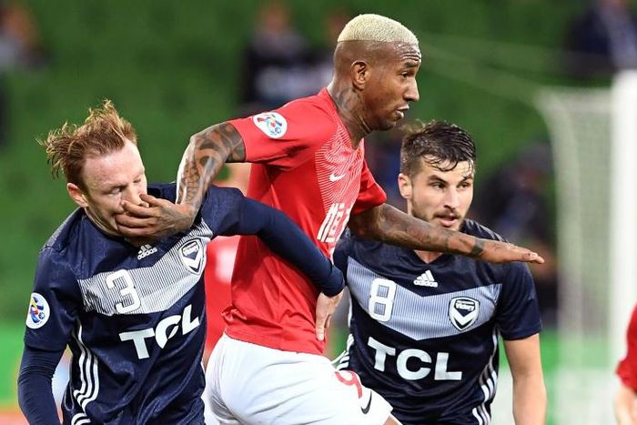 Guangzhou's Anderson Talisca fends off Melbourne Victory's Corey Brown (left) and Terry Antonis