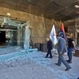 Sadeq al-Keheli (L), interim speaker for a faction of Libyan parliamentarians opposed to strongman Khalifa Haftar, inspects damage at a hotel serving as a HQ in Tripoli
