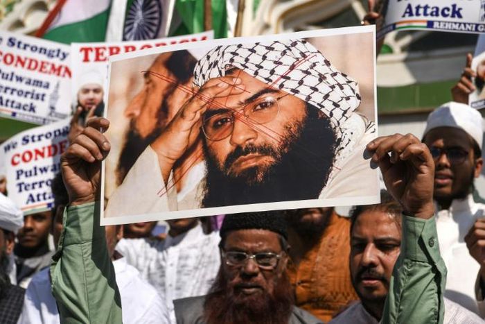 Indian protesters hold a photo of Jaish-e-Mohammad leader Masood Azhar during a protest in Mumbai on February 15, the day after an attack in Kashmir that killed 40 Indian police