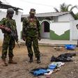 Soldiers look at seized items at the site of an overnight battle between Sri Lankan security forces and suicide bombers in the eastern town of Kalmunai