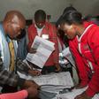 Scrutiny: Polling staff and representatives of political parties monitor the vote count at a polling centre in Blantyre