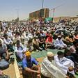 Sudanese demonstrators hold Friday prayers at the protest camp outside army headquarters in Khartoum