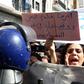 An Algerian protester holds sign that reads "My country is drowning in a sea of corruption"