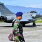 Indonesian soldiers stand guard near one of the seven French fighter jets which were forced to make an emergency landing due to bad weather