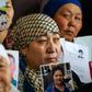 Petitioners with relatives missing or detained in Xinjiang hold up photos of their loved ones during a press event at the office of the Ata Jurt rights group in Almaty, Kazakhstan, on January 21, 2019.