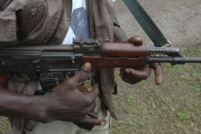 Photo of a gunman wirlding an AK 47 riffle (Pools Online)