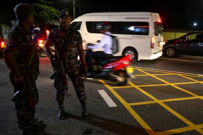 Sri Lankan security personnel stand guard at a checkpoint on a roadside in Colombo on May 13, 2019. A Muslim man was slashed to death in Sri Lanka, police said after imposing a nationwide curfew to contain a violent new backlash against Easter suicide ...
