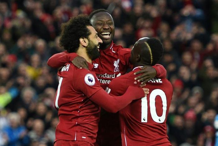 Guinean Naby Keita (C) celebrates his goal for Liverpool against Huddersfield Town with Egyptian Mohamed Salah (L) and Senegalese Sadio Mane.