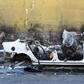 The Mare favela in Rio de Janeiro is notorious for the heavy influence of drug traffickers -- here, a resident smokes crack beside the shell of a disused and burnt out car there