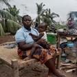 Maria Mendosa, Assan Madal and their children are among those without shelter in the village of Nacate, south of Macomia