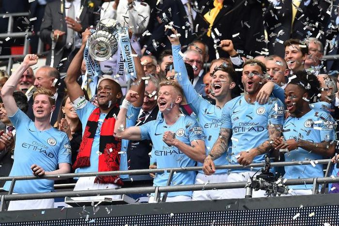 Manchester City captain Vincent Kompany lifts the FA Cup after their final rout of Watford