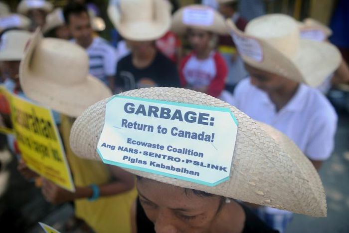 Environmental activists rallying outside the Philippine Senate in Manila in 2015 to demand that scores of containers filled with household rubbish be shipped back to Canada
