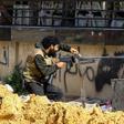 A Libyan fighter from the UN-recognised Government of National Accord fires a machinegun during clashes with forces loyal to strongman Khalifa Haftar south of the capital Tripoli's suburb of Ain Zara on April 10, 2019