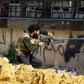 A Libyan fighter from the UN-recognised Government of National Accord fires a machinegun during clashes with forces loyal to strongman Khalifa Haftar south of the capital Tripoli's suburb of Ain Zara on April 10, 2019