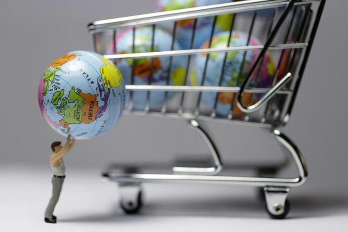 (FILES) In this file illustration made in Paris on November 8, 2015 shows a figurine with a globe next to a miniature shopping cart.Scientists and diplomats from 130 countries are meeting from April 29, 2019 in Paris to adopt the first global assessmen...