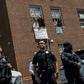 Pro-Nicolas Maduro supporters and activists occupying the Venezuelan embassy in Washington waved earlier this week from a window to Reverend Jesse Jackson (unseen) who came to support them. The opposition said Thursday the building had been cleared by ...