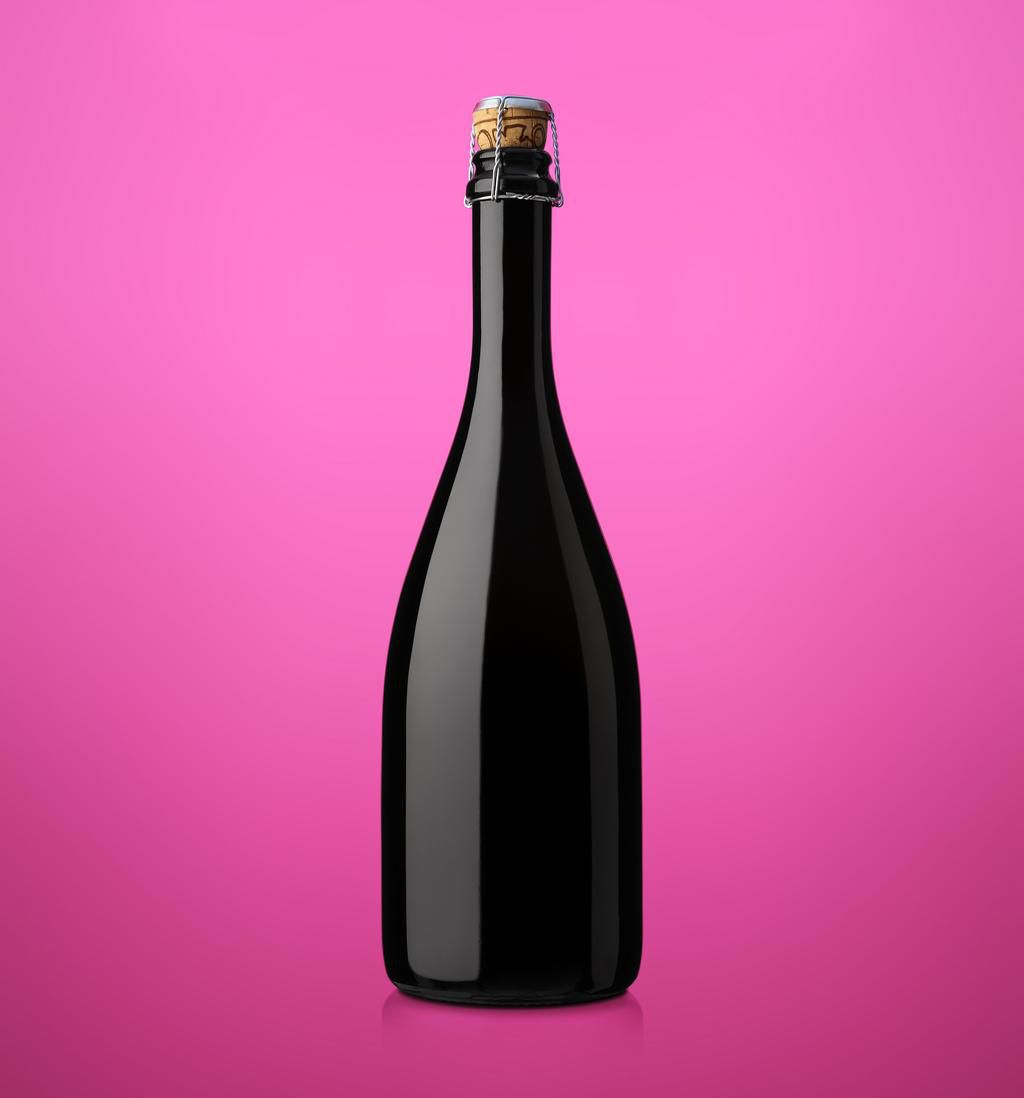 bottle of sparkling wine with cork on a colored background